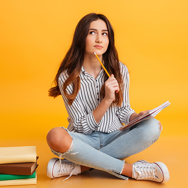 girl thinking while writing